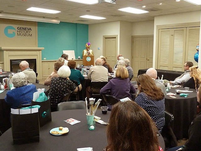 Mister Vibe at the podium speaking to a large group about handwriting analysis.