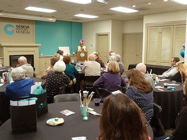 Mister Vibe at the podium speaking to a large group about handwriting analysis.