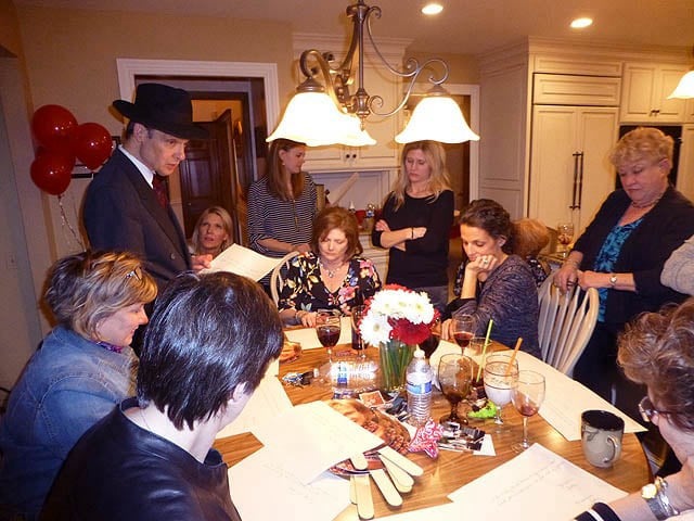 Mister Vibe analyzes the handwriting of teens seated at a long dining room table.